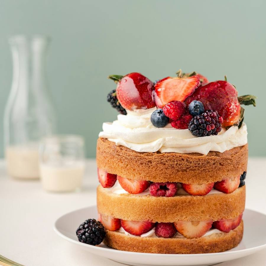 Two-tier buttercream cake with fresh flowers