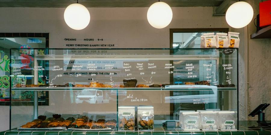 Bakery interior with a pastry case and café tables